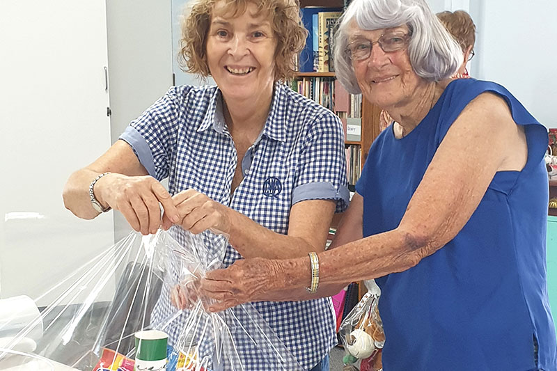QCWA members Julie Blinkhorn and Thelma Bromley packing Christmas hampers