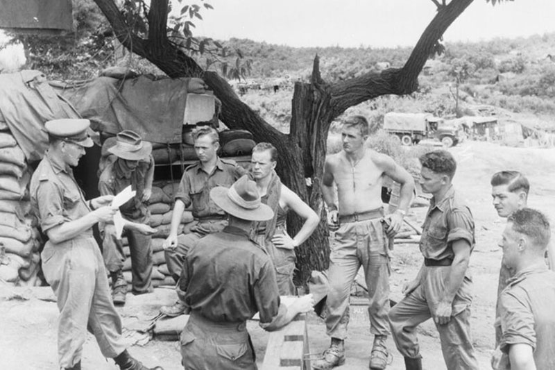 Image: Imperial War Museum MH 32765 | MAJ Wilson of the 2nd Battalion Royal Australia Regiment reads ceasefire instructions to Headquarters personnel.