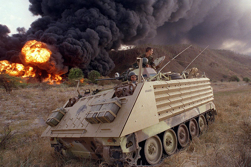 Image: Defence Australia | A New Zealand Armoured Personnel Carrier secures the surrounding area near the scene of exploding asphalt drums which were set ablaze on the outskirts of Dili.