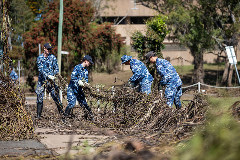 Image: Defence Australia | RAAF members help clean up a park in Moree, NSW after recent flooding.