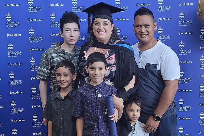 Cassandra Ladesma at her university graduation ceremony alongside her family 