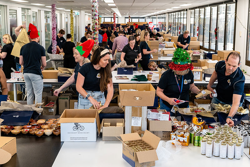 RSL Queensland staff and volunteers packing Christmas hampers. 