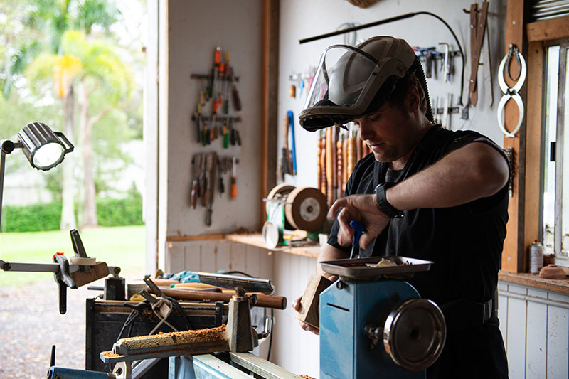 Army veteran Kerry Corney prepping a wood block to be turned into a wooden bowl. 