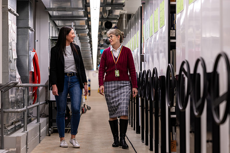 2 women walking in gallery