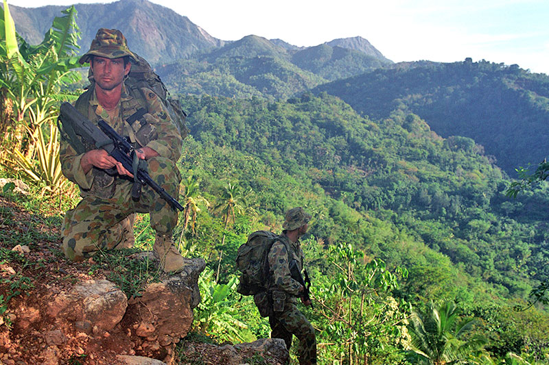 Image: Defence Australia | Sergeants Marty Ryan and Gary Boylan move carefully across the mountains near the border area where Australian Commandos operated in World War Two. 