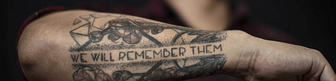 Tattoo on arm that says "We will remember them"